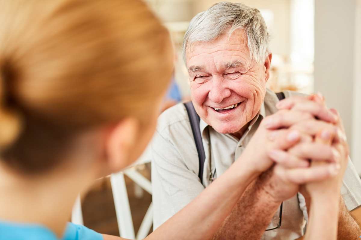 a happy, elder man in assisted living
