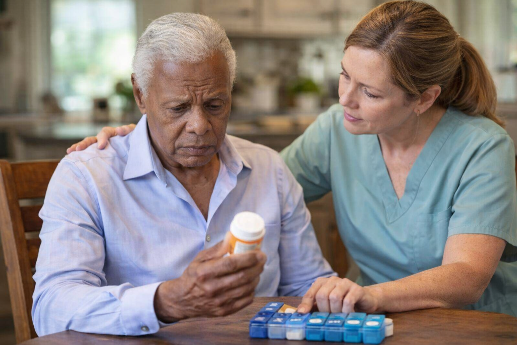 Caregiver helping a senior with memory loss review medication at home, highlighting need for assisted living and memory care in Palm Beach County