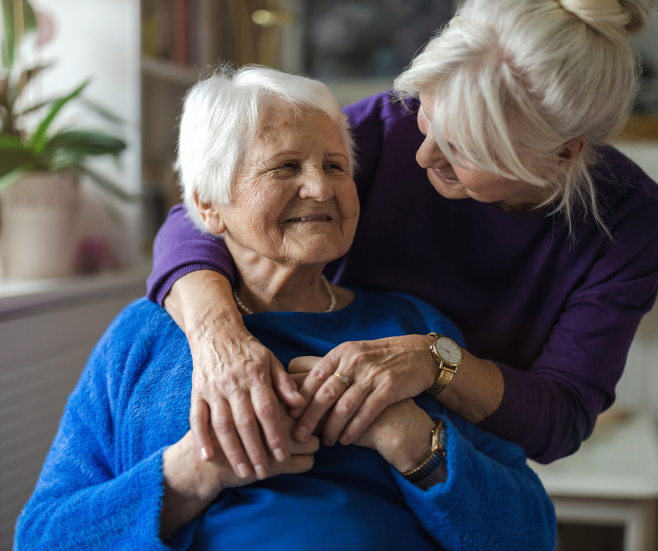 Daughter comforting elderly mother during senior care transition at home in Palm Beach County