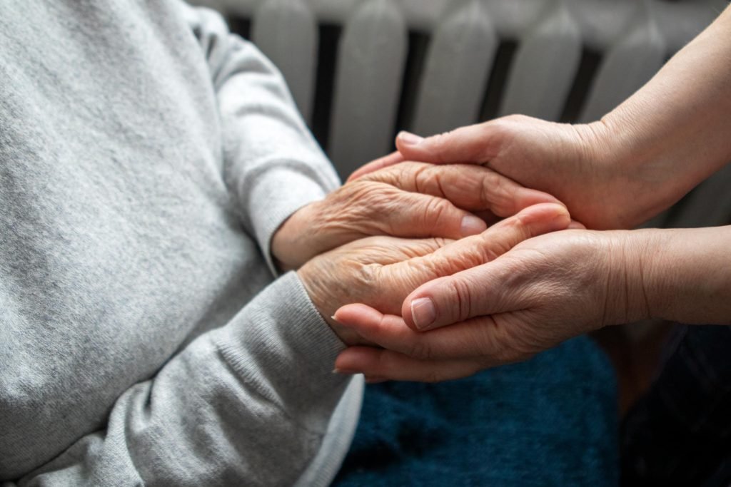 Care advisor supporting an elderly woman during a senior living placement consultation at home