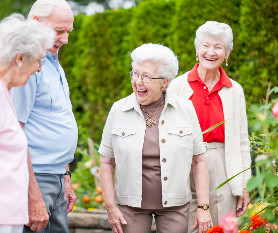 Older adults laughing and talking at a senior living community in Lake Worth Beach, Florida