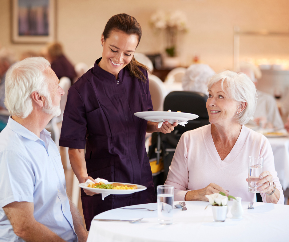 Older couple eating at a senior living community in Royal Palm Beach, Florida